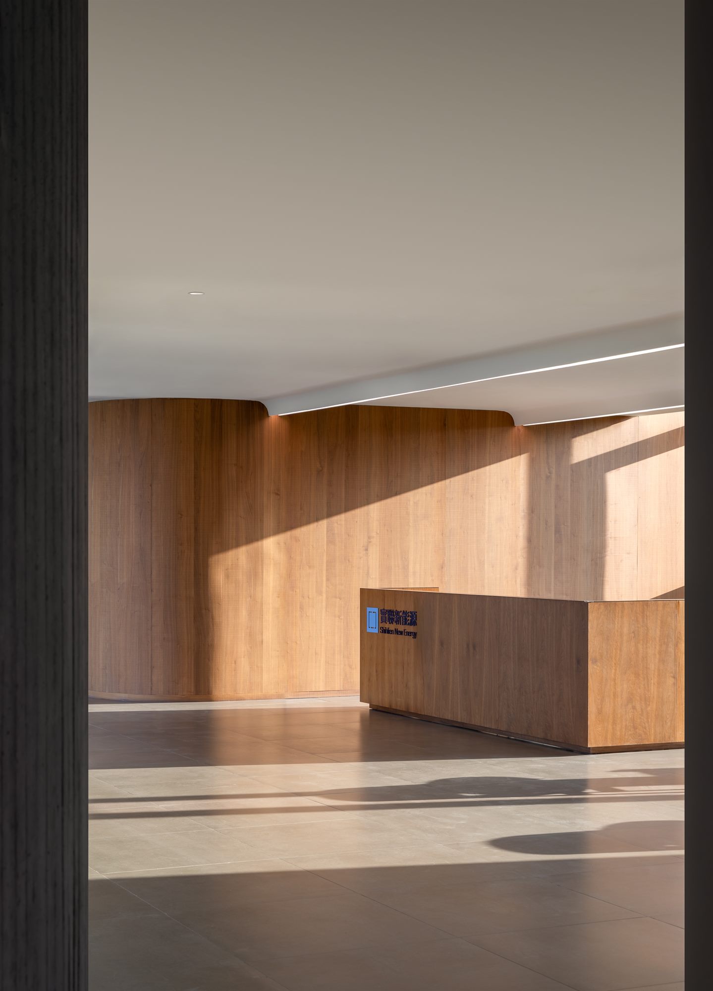 View through a doorway into a timber-lined reception, Shihlien battery plant office