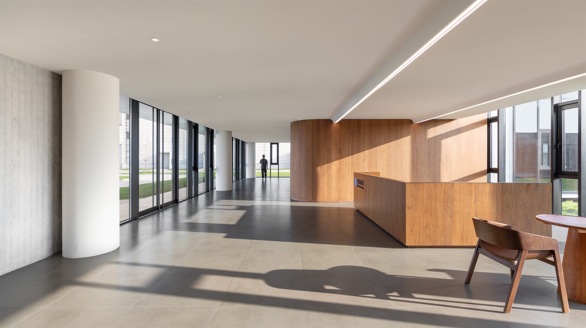 Reception area with timber wall and full-height windows, Shihlien battery plant
