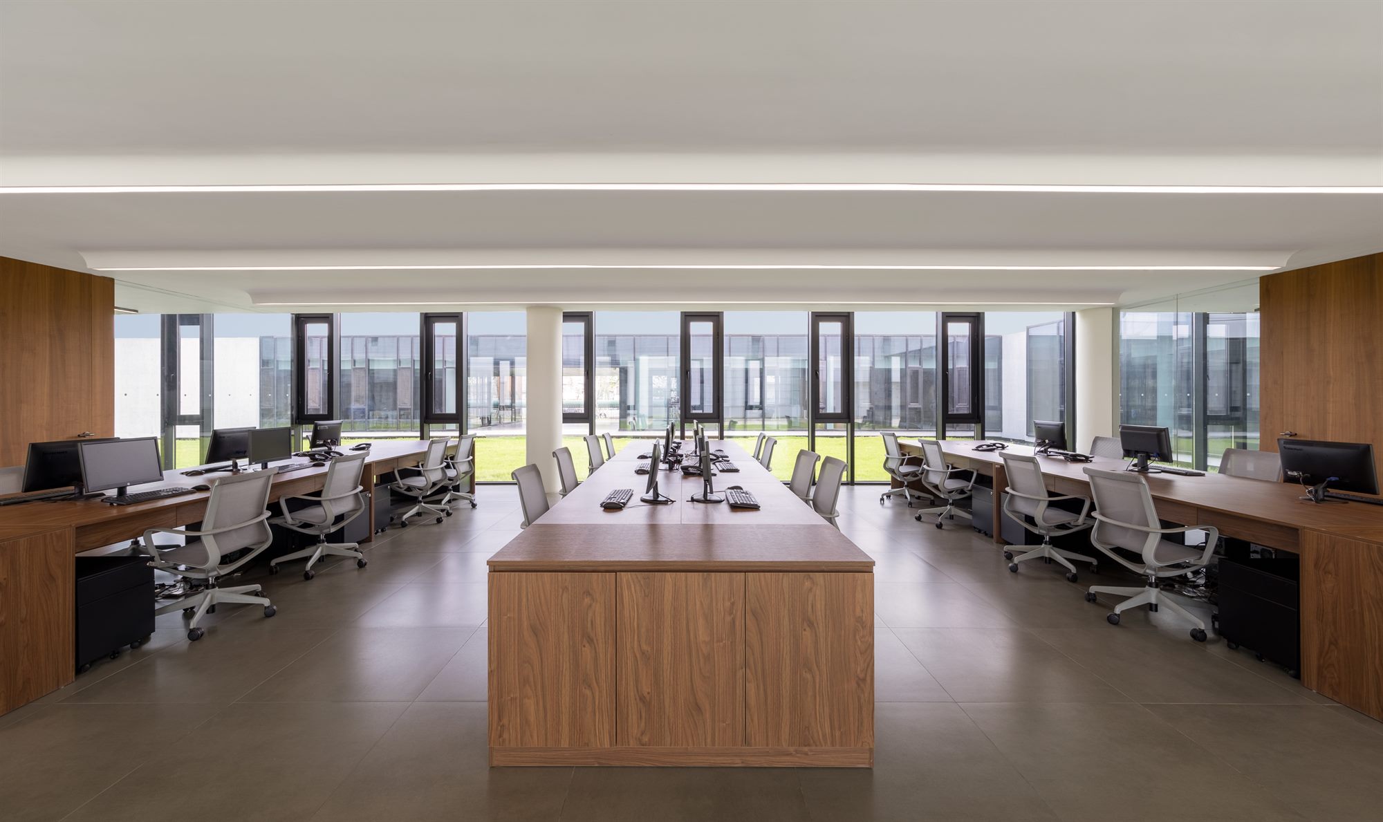 Open office area with timber desks and seating, Shihlien battery plant office