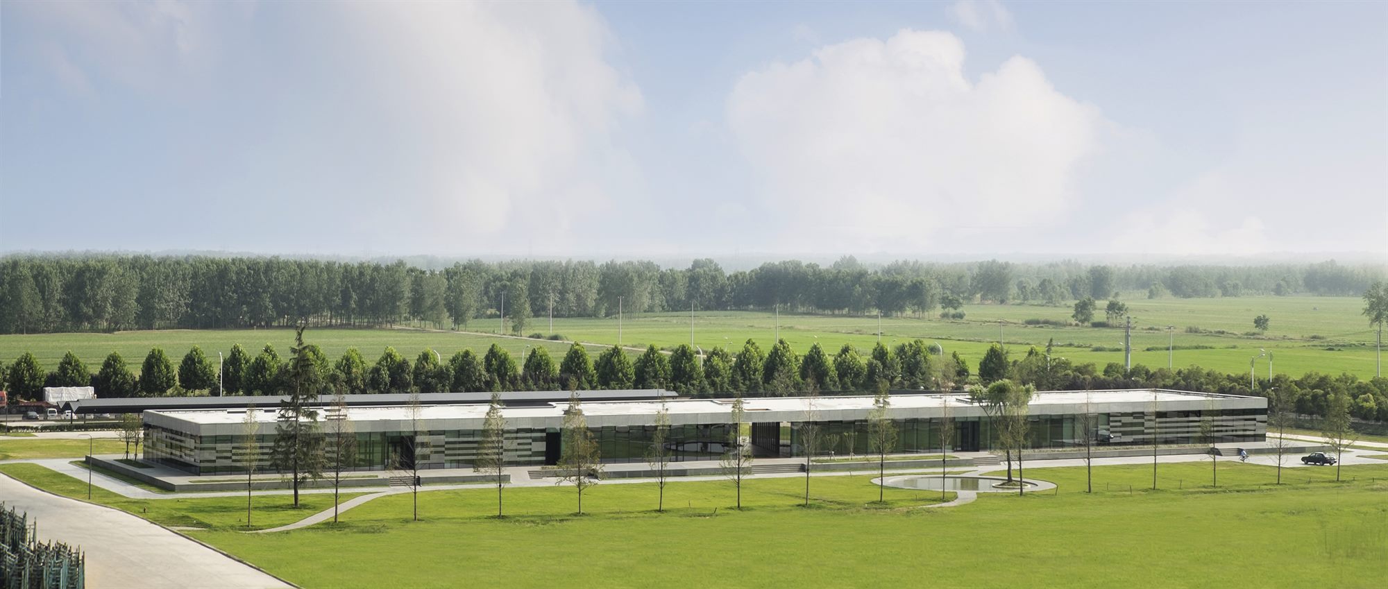 Taiwan Glass Donghai office building: a 150-metre glass box displayed like a piece of jewellery on a podium, Jiangsu