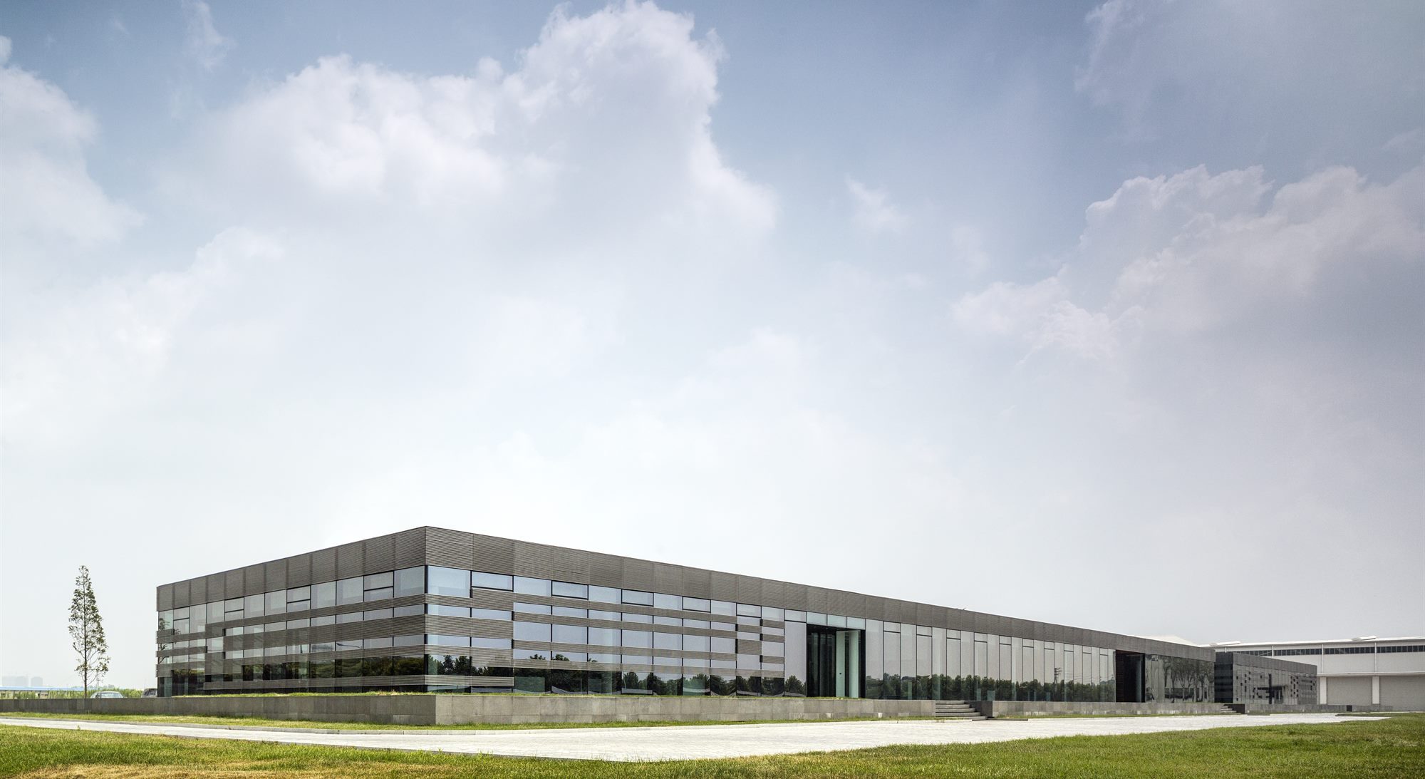 Taiwan Glass Donghai office building: a 150-metre glass box displayed like a piece of jewellery on a podium, Jiangsu