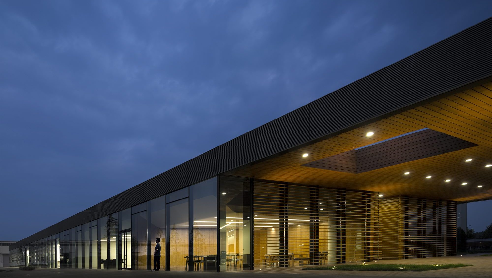Lit glass façade of the Donghai office building at night