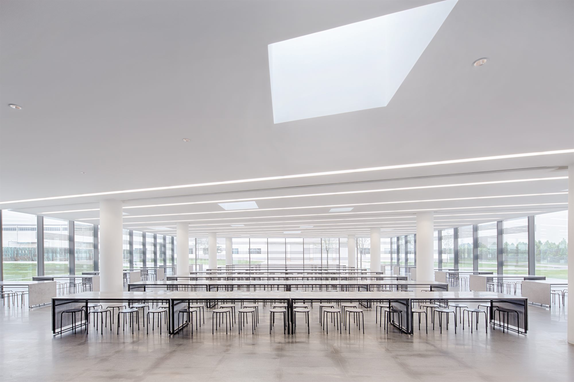 Large canteen with skylight and custom-designed long tables, Donghai office building