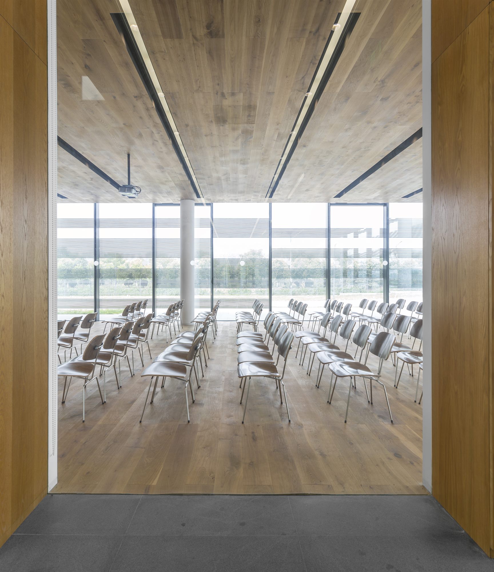 View through glass into the timber-lined lecture hall, Donghai office building