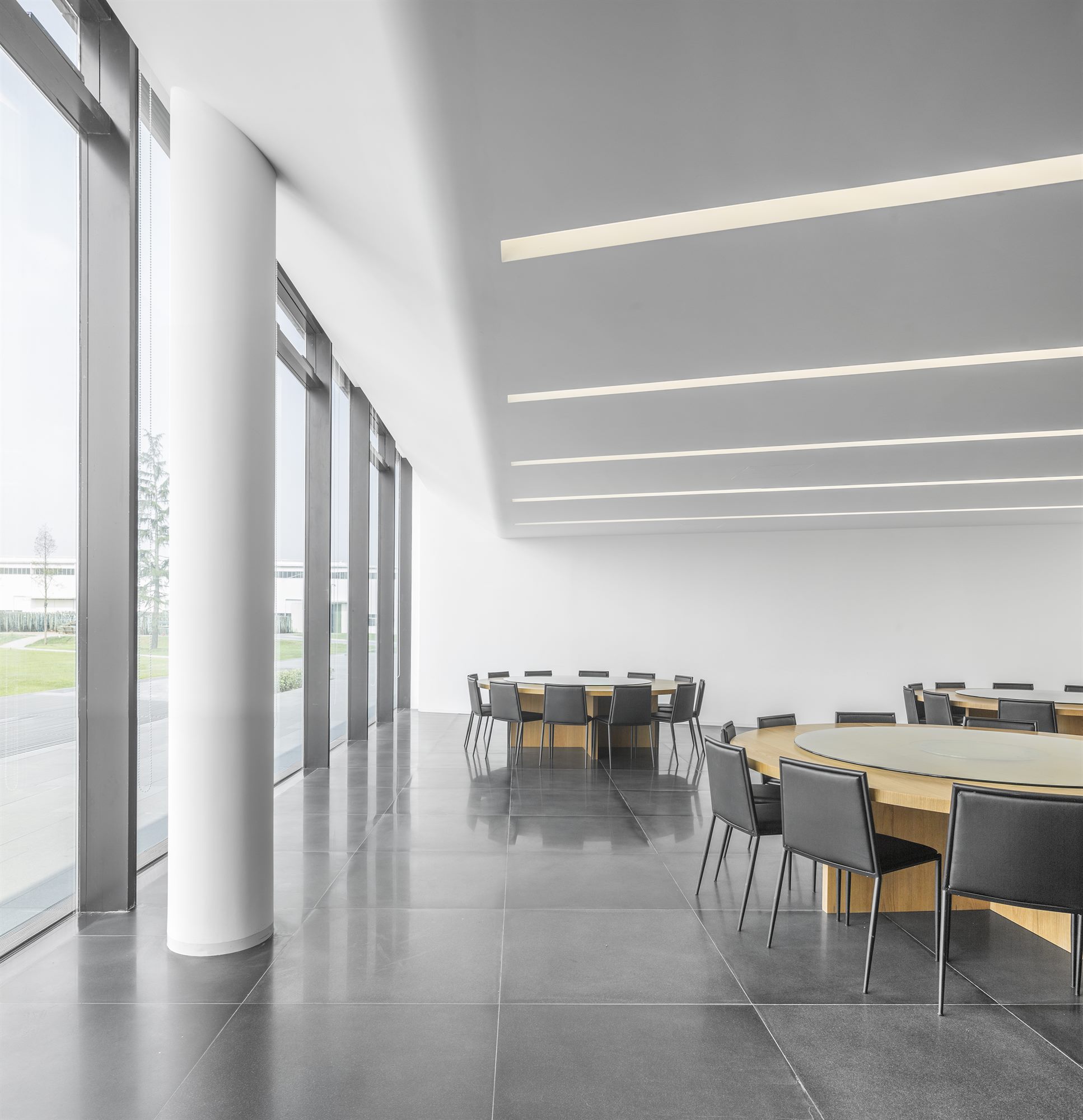 Bright dining area for staff with linear ceiling lights, Donghai office building