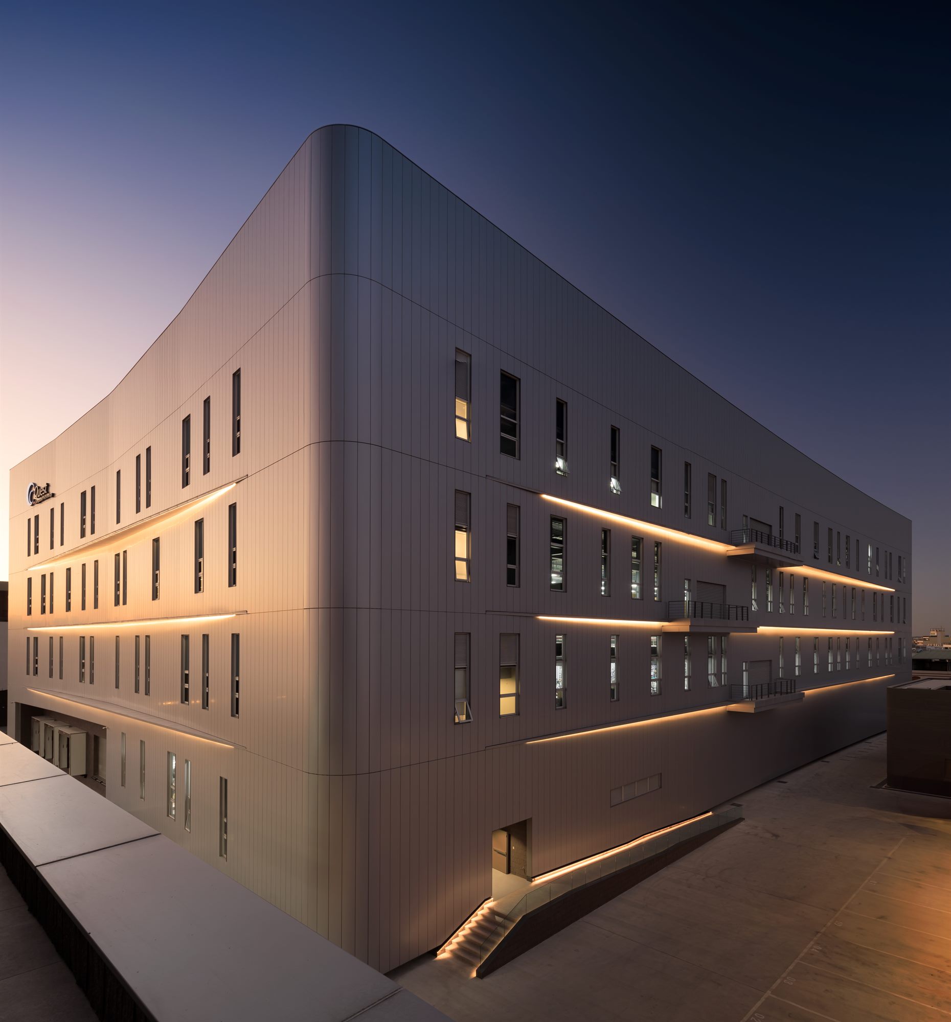 Quest Composite factory building at night with lit sun blades
