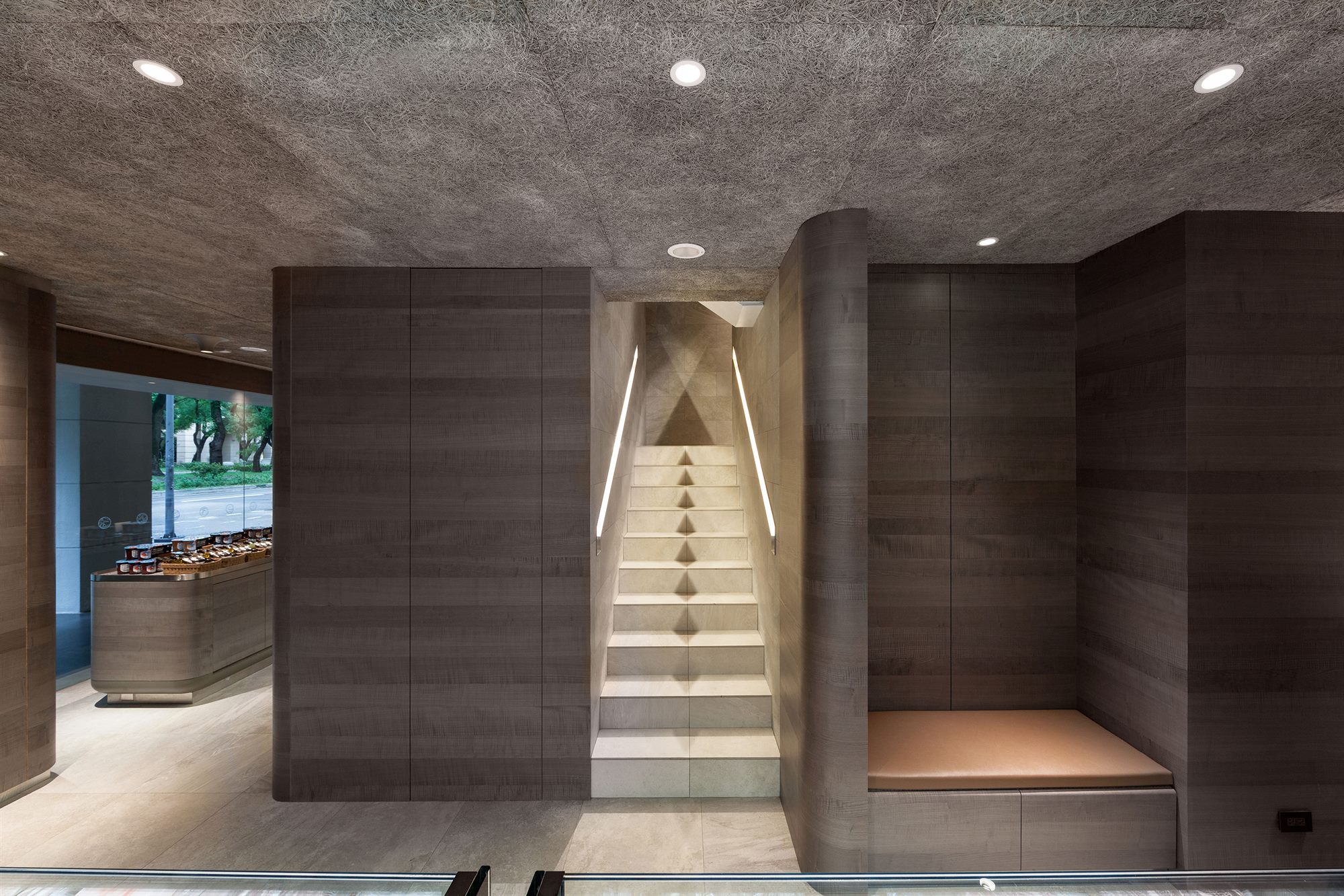 Lit staircase between grey-toned timber walls, ROU by T-HAM