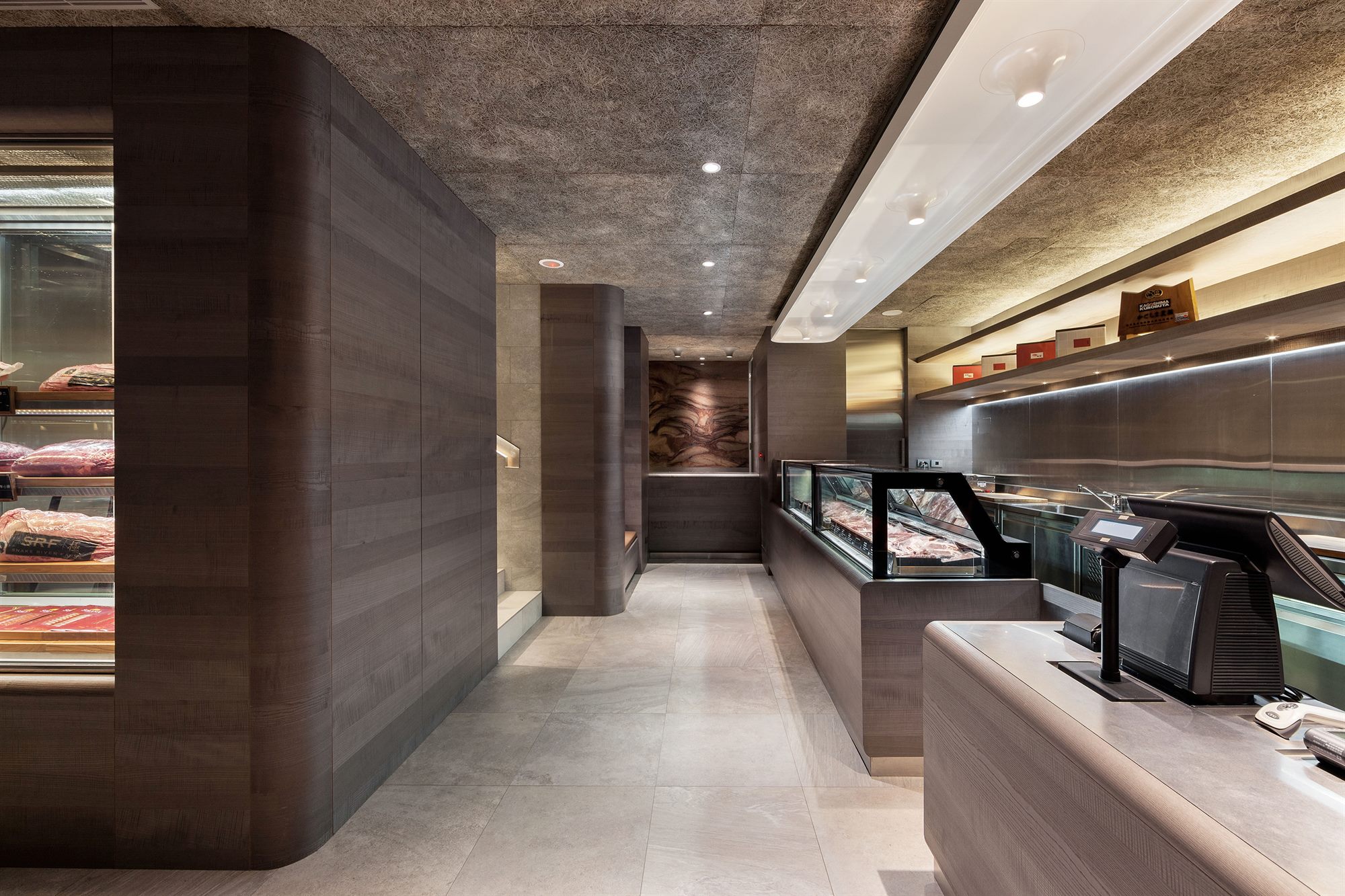 Deli counter under a concrete ceiling, ROU by T-HAM
