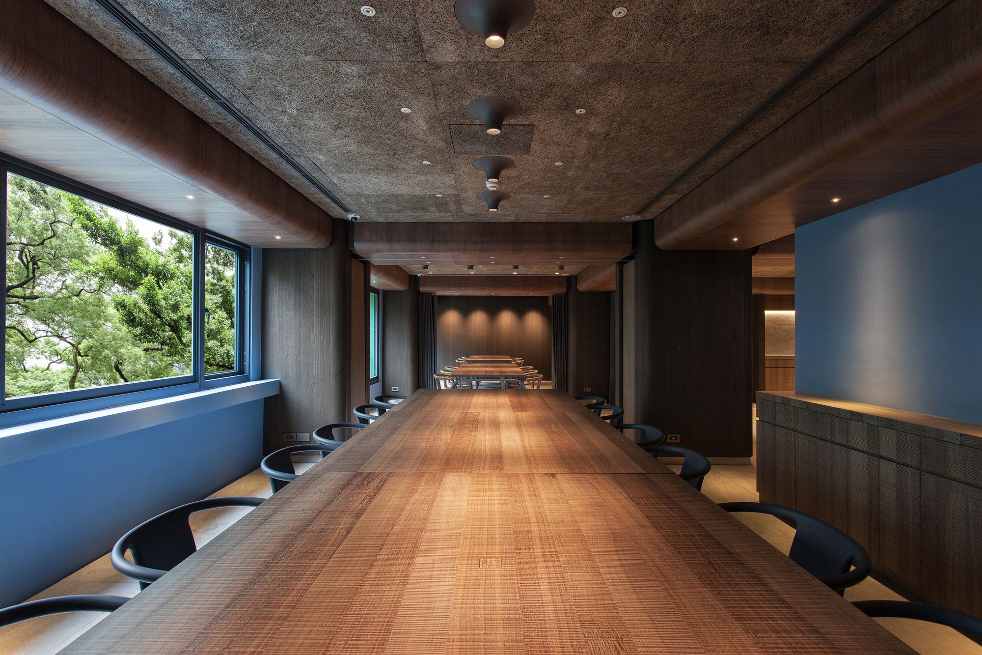 Long communal dining table with window views, ROU by T-HAM restaurant