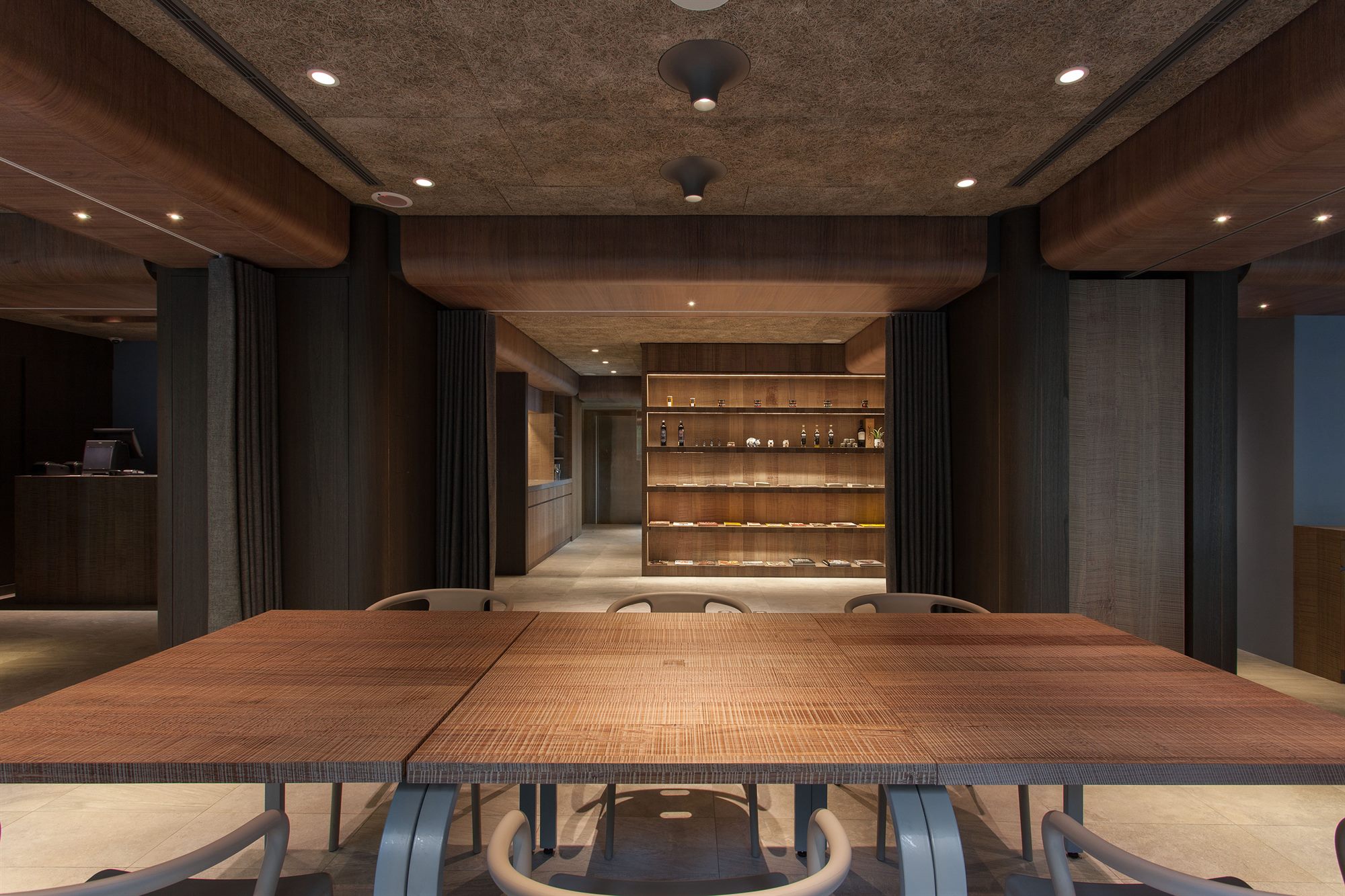 Restaurant tables between dark timber columns, ROU by T-HAM