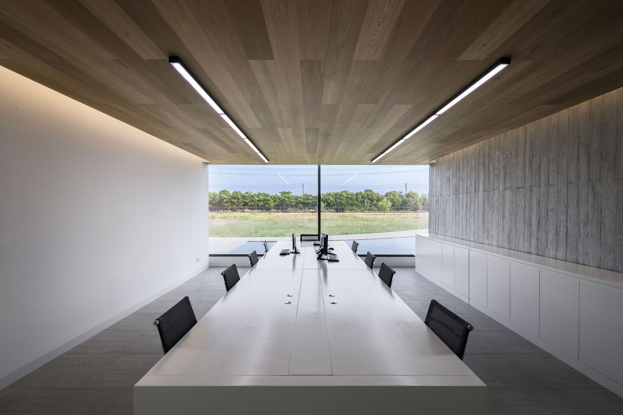 Office with timber ceiling and a full-width window framing the landscape, salt laboratory