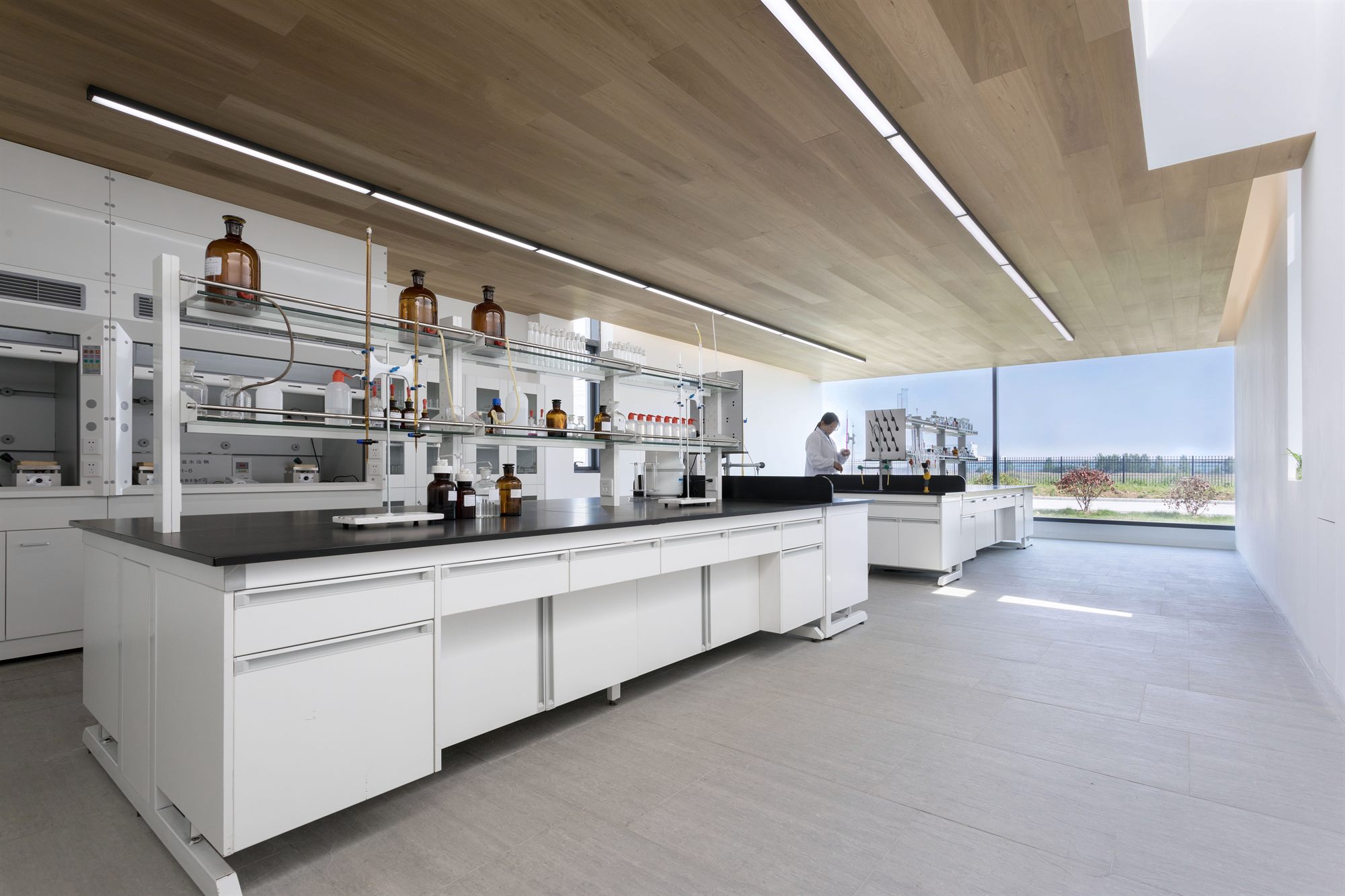 Laboratory with white benches, timber ceiling and panoramic windows, Shihlien salt laboratory