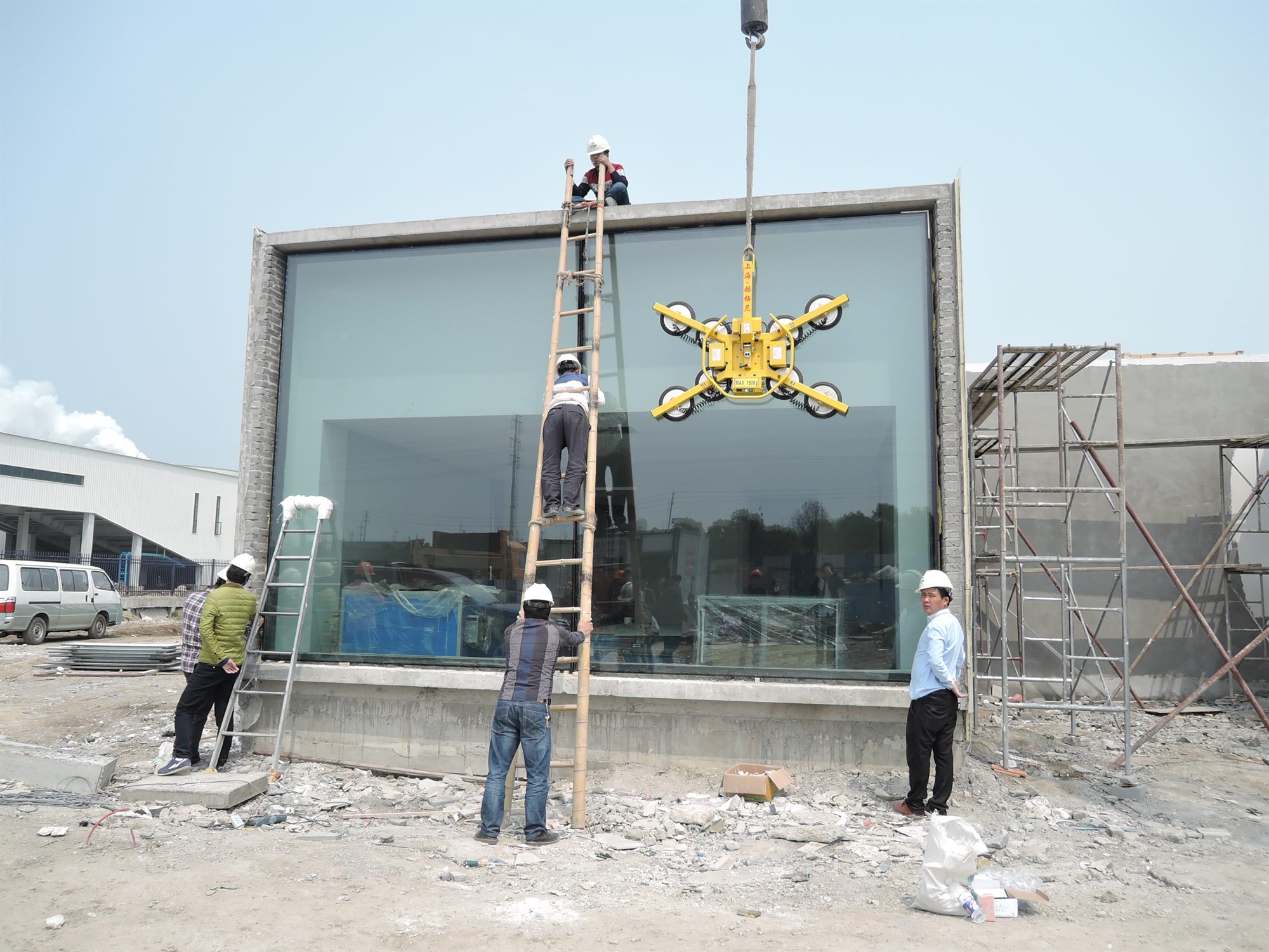 Workers installing a large triple-glazed Low-E window during construction of the salt laboratory