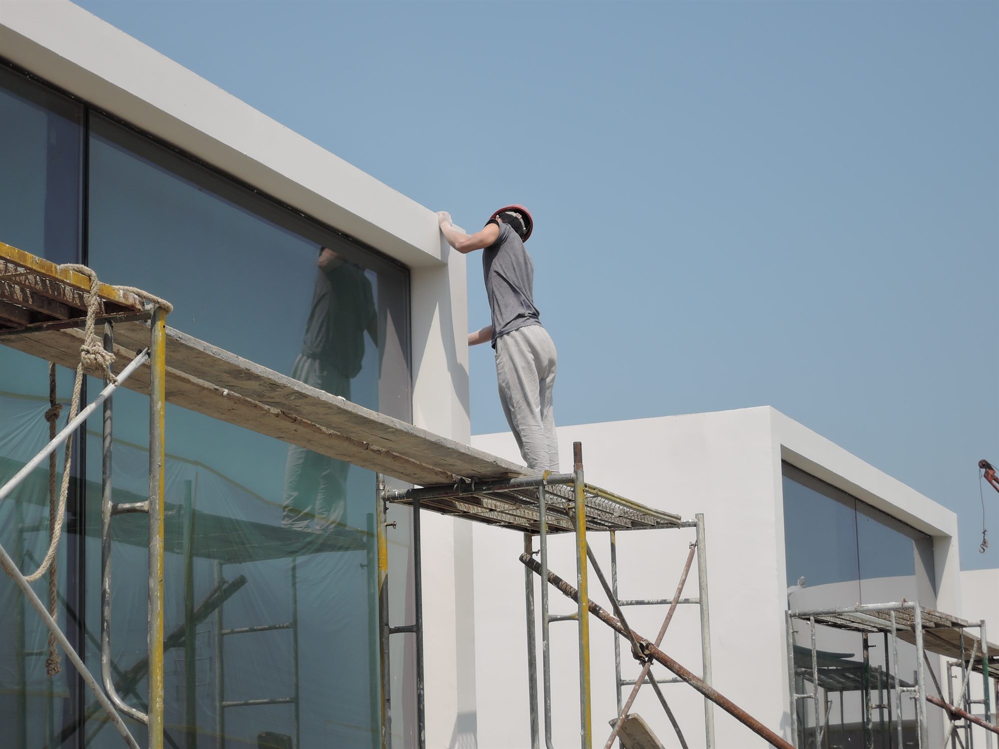 Builders on scaffolding fitting glazing during construction of the salt laboratory