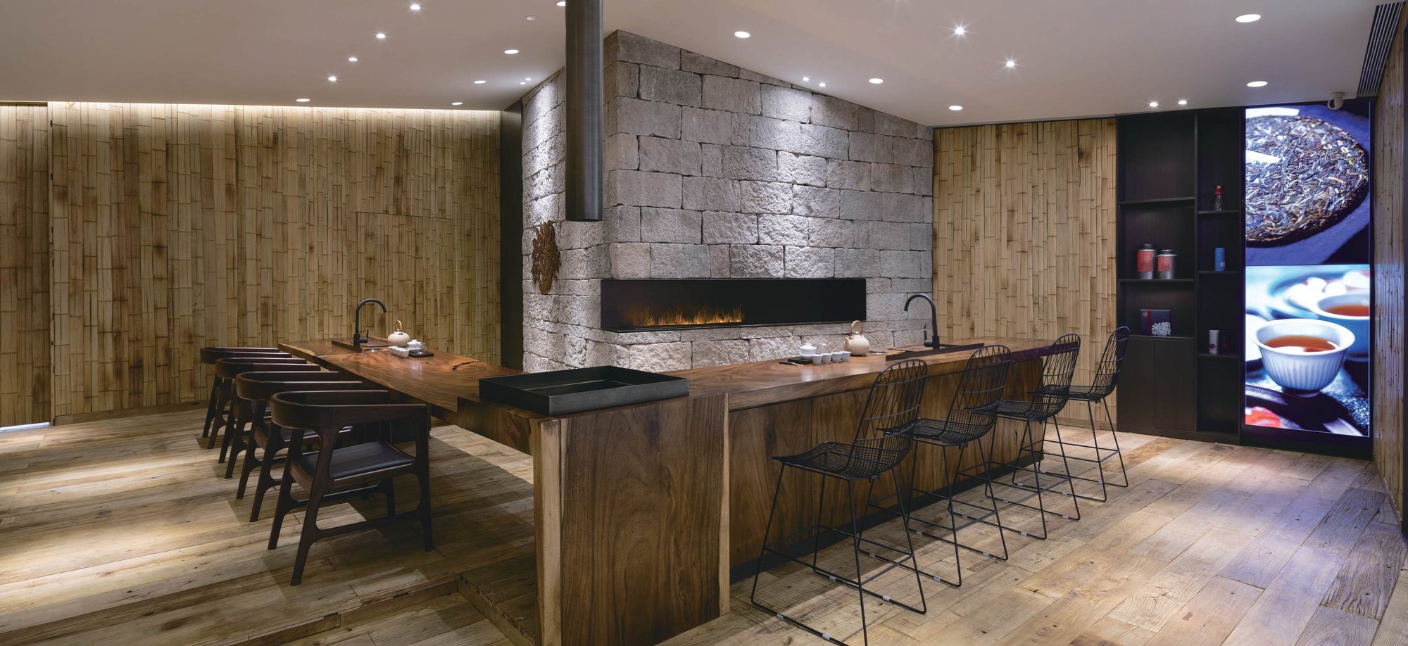 Walnut tea bar, stone fireplace and bamboo walls, Shan Tea concept store, Guangzhou