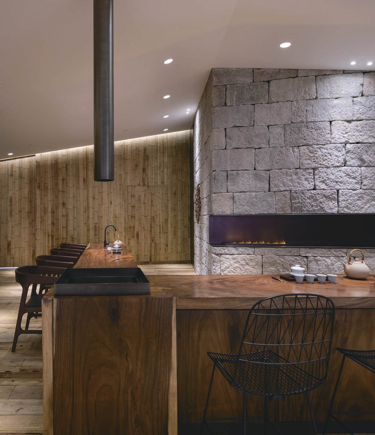 Walnut tea counter beside the stone fireplace, Shan Tea concept store
