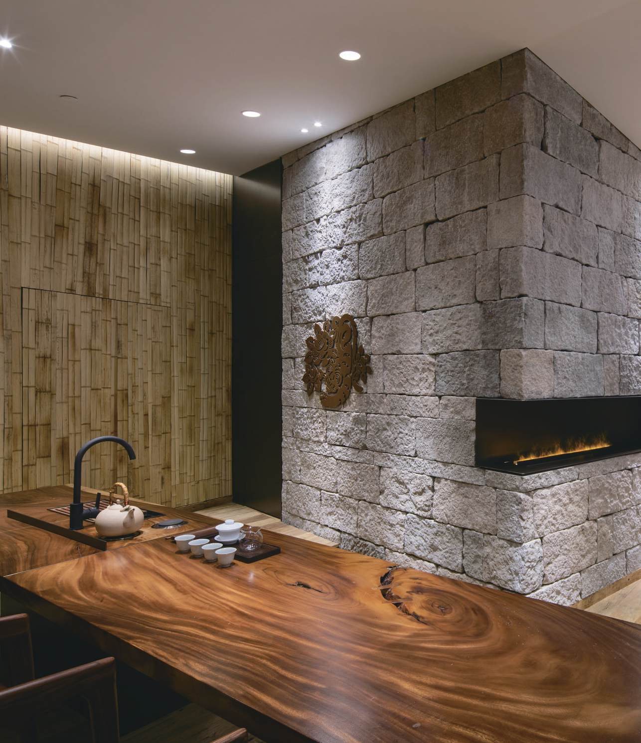Live-edge walnut tea table in front of the stone hearth, Shan Tea concept store
