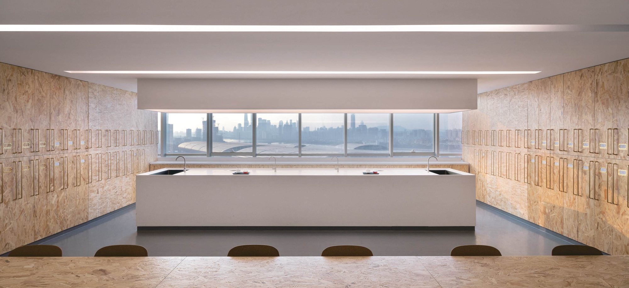 Blending lab with a central island and OSB sample cabinets, overlooking Guangzhou