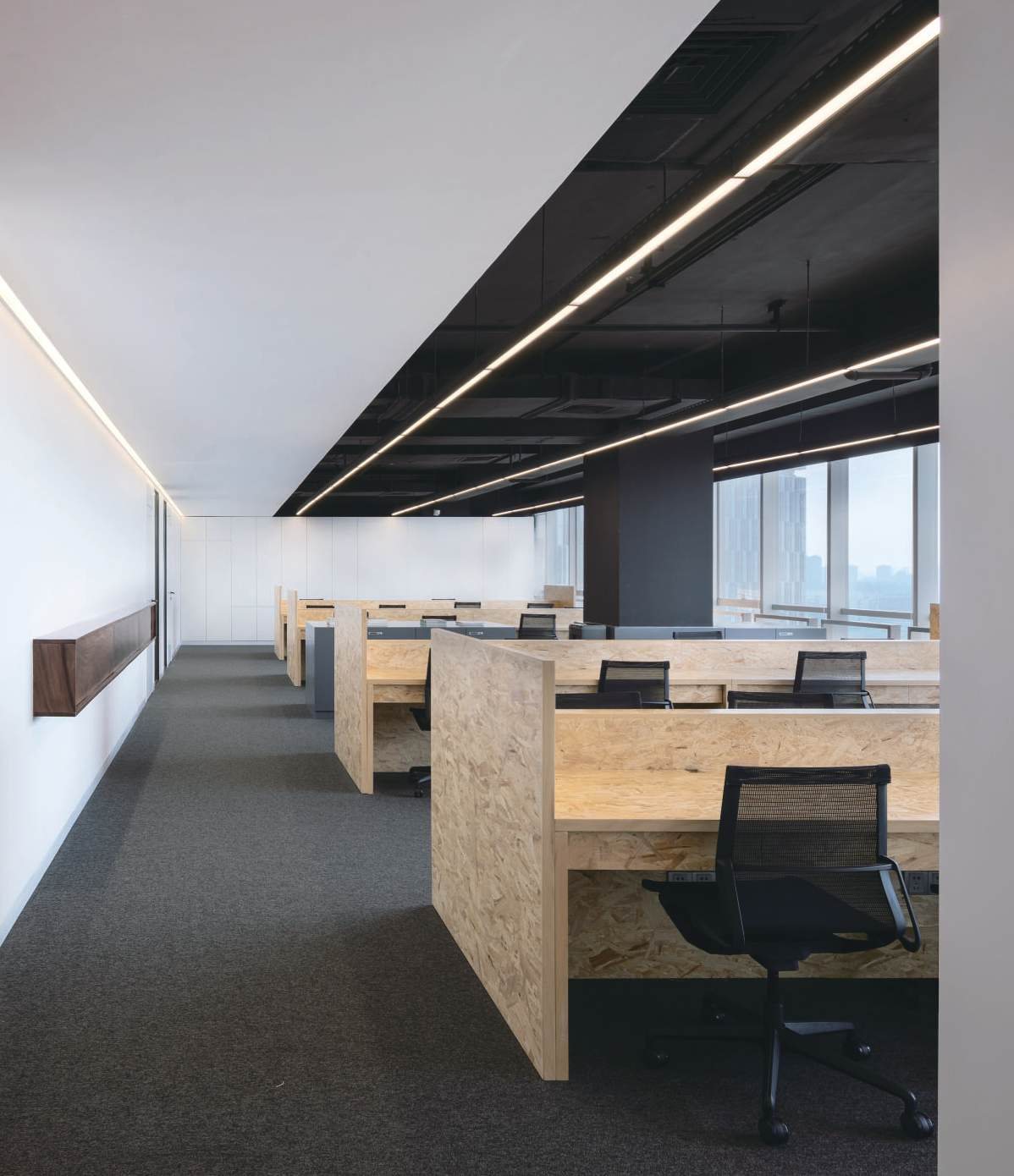 Open office with OSB desks under linear lights, Shan Tea R&D centre