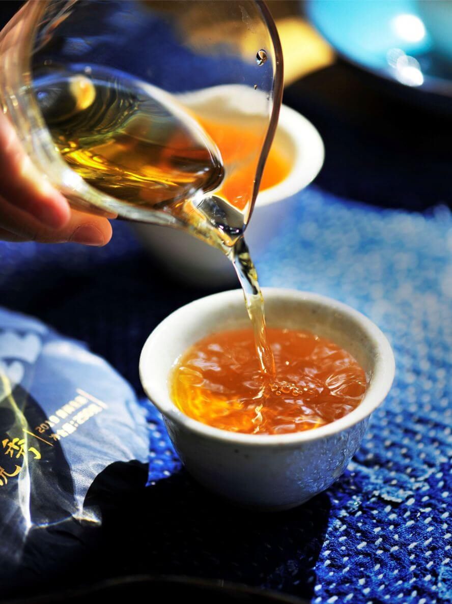 Pu'er tea being poured into a small cup, Shan Tea