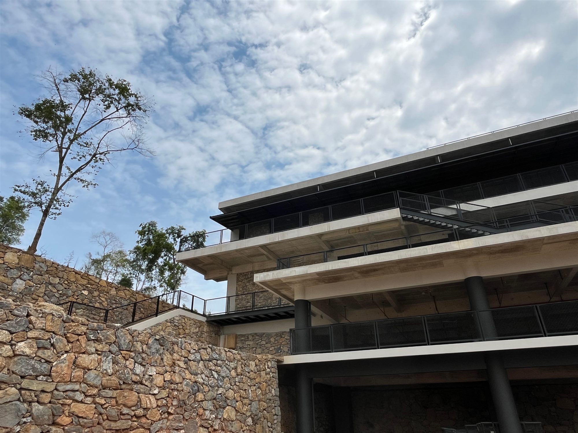 Layered roofs of the Shan Tea factory above stone retaining walls
