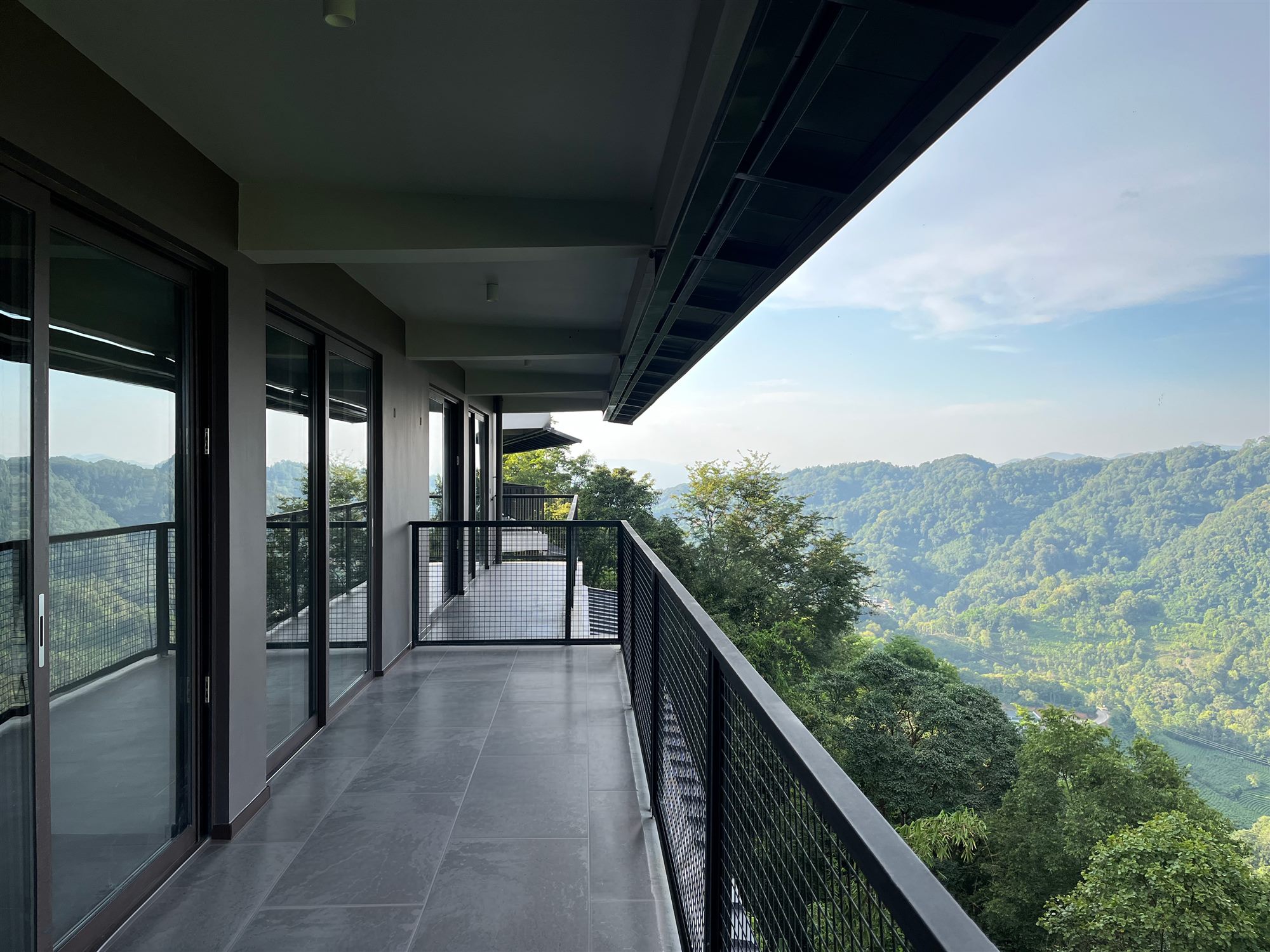 Glazed walkway along the Shan Tea factory with mountain views