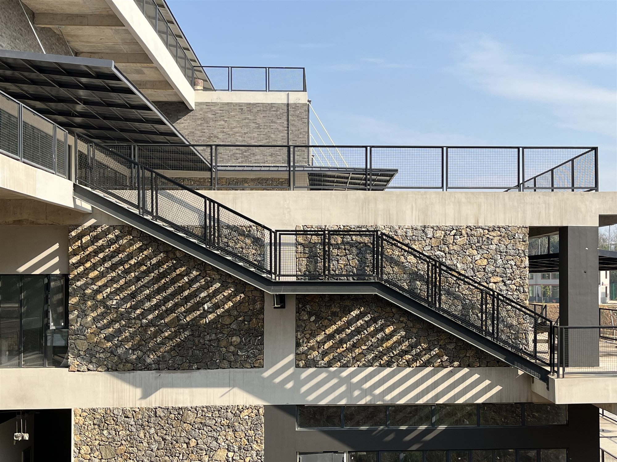 External steel staircases on the stone-based Shan Tea factory building