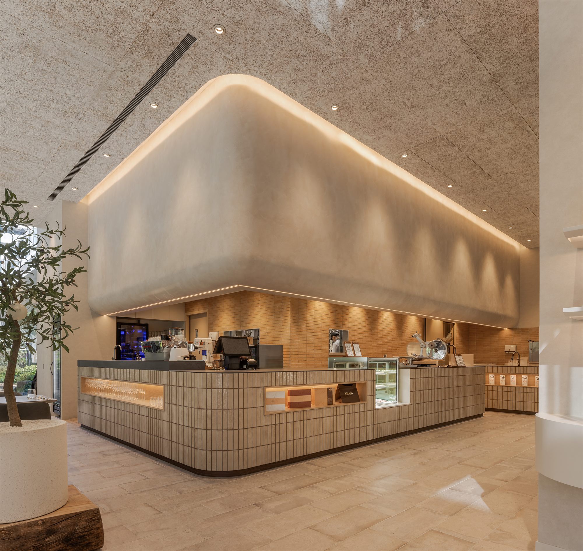 Curved deli counter under a cove-lit ceiling, ROU × James Sharman