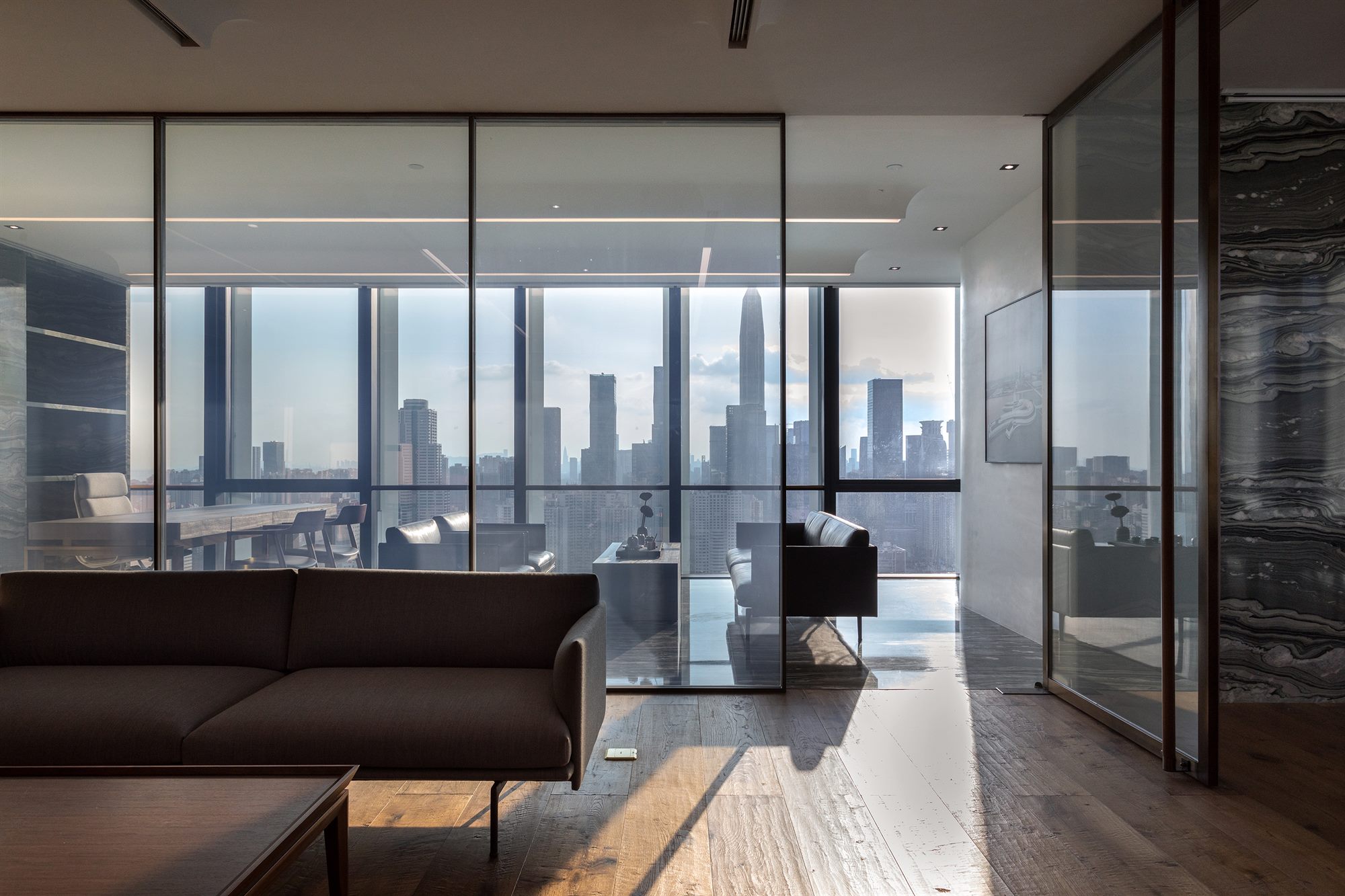 Executive office with sofa and panoramic Shenzhen skyline view