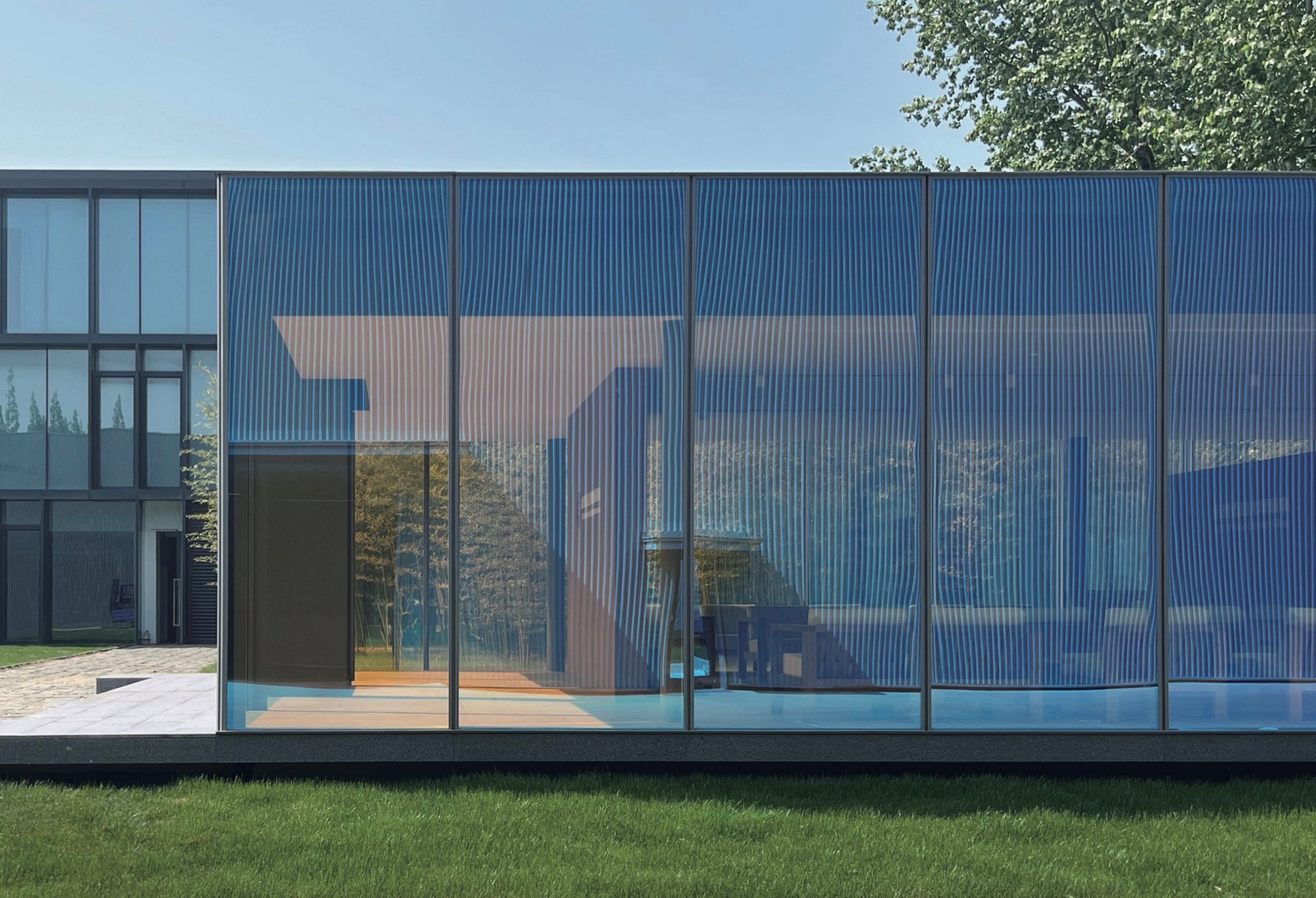 Purple-tinted dichroic glass façade of the Taiwan Glass Qingdao showroom