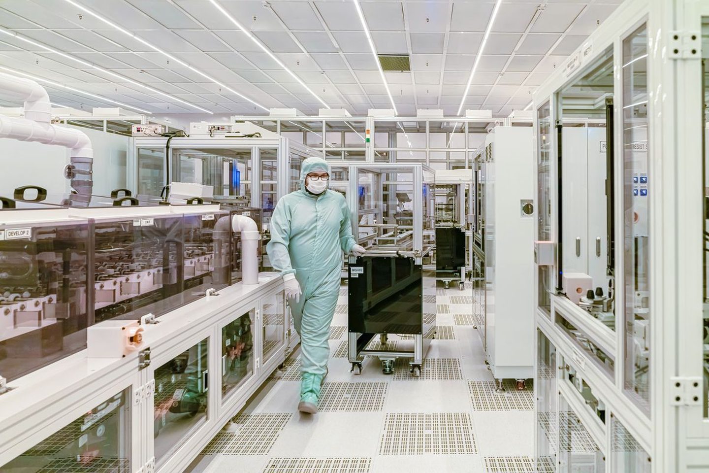 Technician on a cleanroom electronics production floor