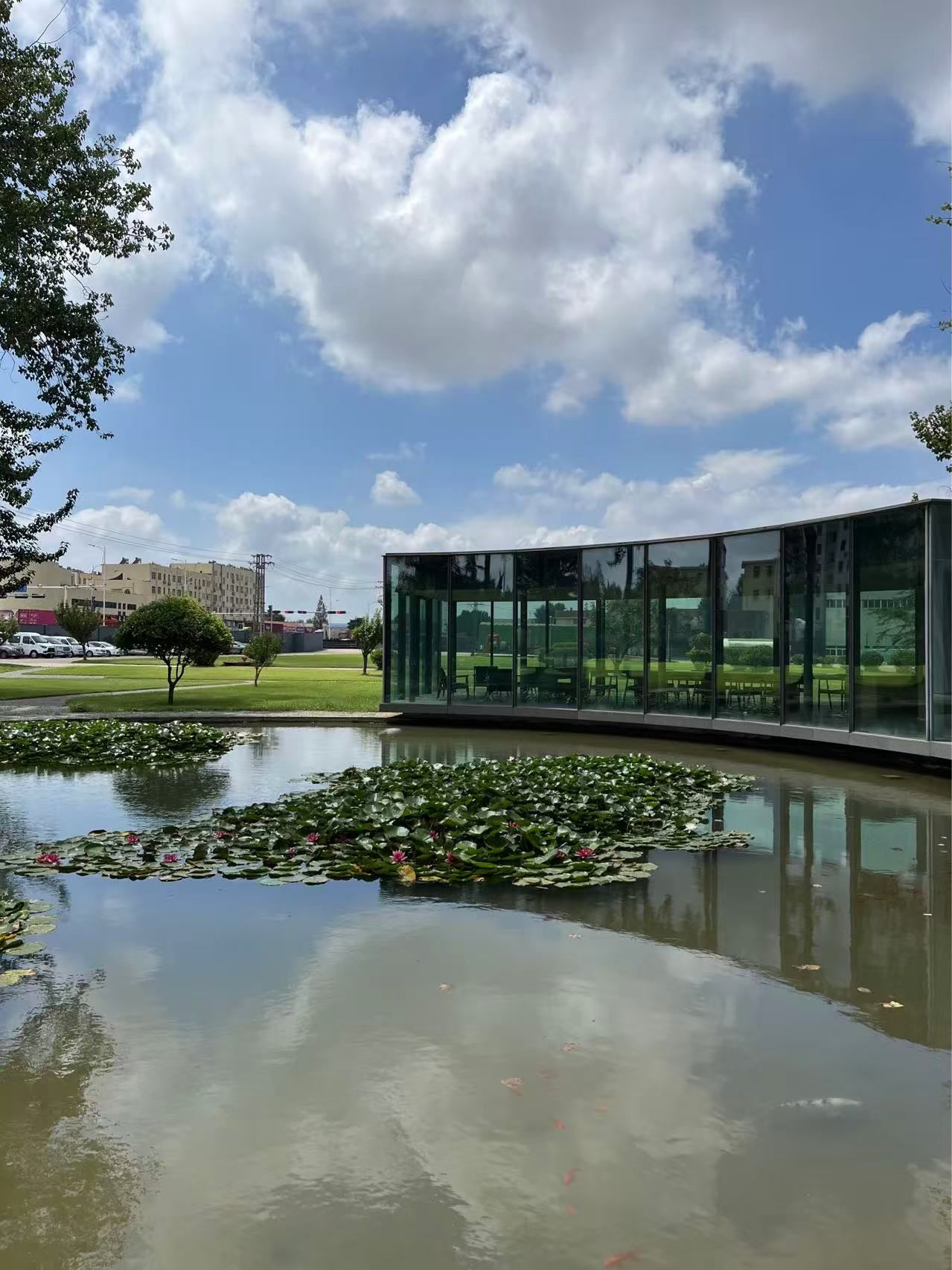 Vacuum glass pavilion reflected in a pond, Taiwan Glass Qingdao garden