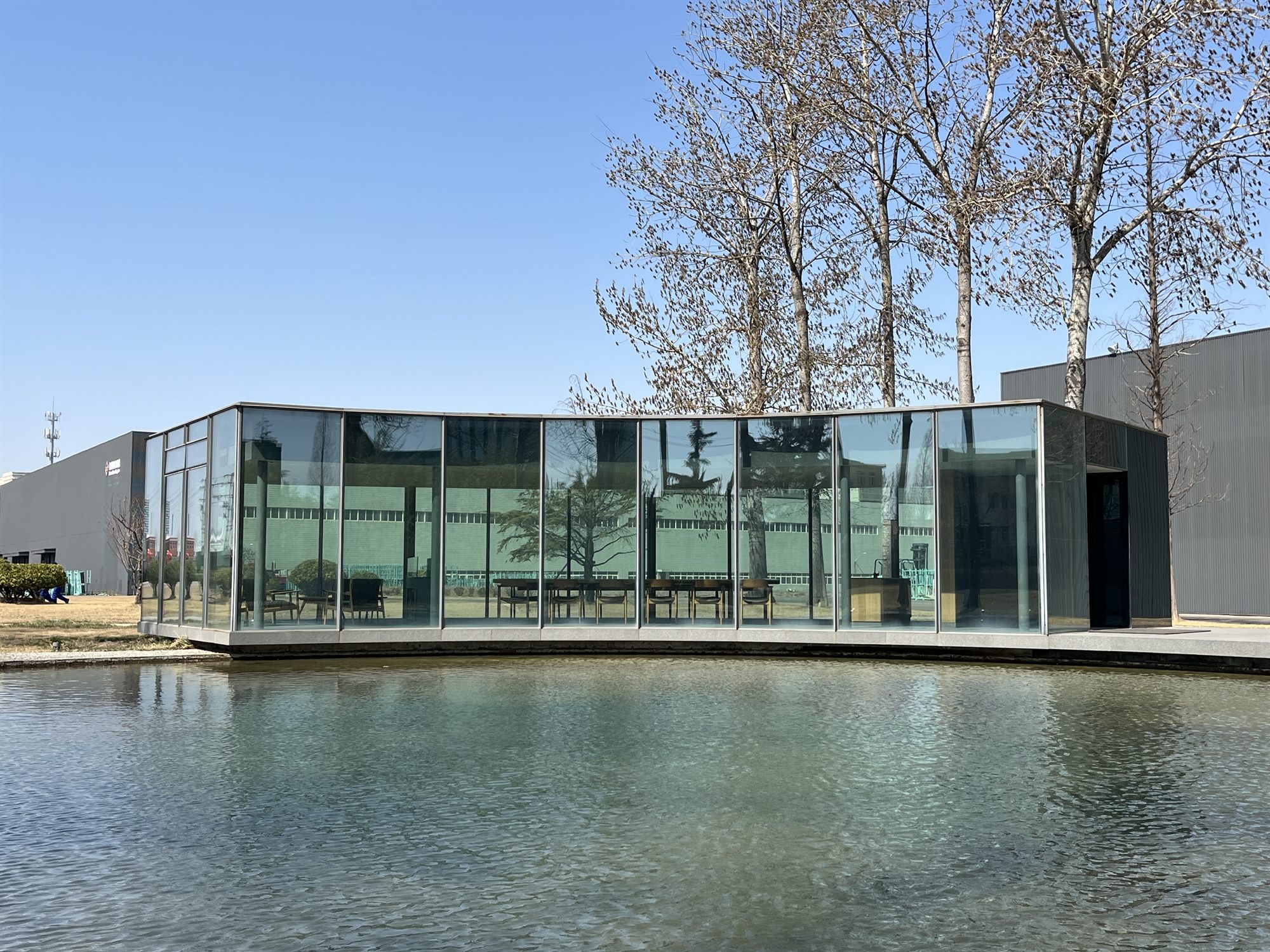 Vacuum glass pavilion beside a pond and trees, Taiwan Glass Qingdao
